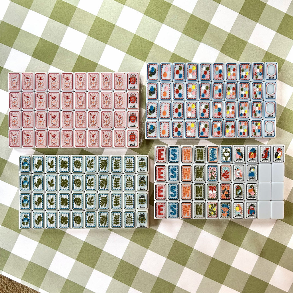 Set of colorful mahjong tiles on a checkered tablecloth