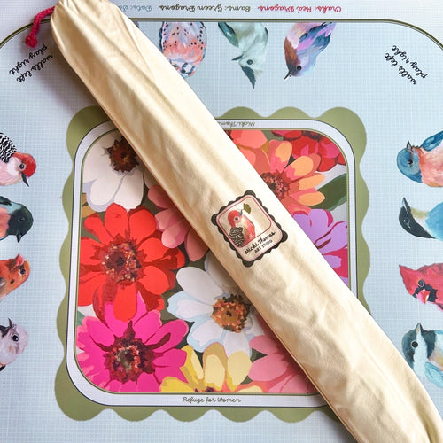 colorful mahjong mat with flowers and a canvas mat bag with a bird on it sitting on top